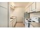 Compact kitchen featuring white appliances and tile countertops, perfect for easy meal preparation at 3313 N 68Th St # 111, Scottsdale, AZ 85251