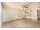 Living area with a ceiling fan, tile floor, and an open layout flowing into the kitchen area at 3313 N 68Th St # 111, Scottsdale, AZ 85251