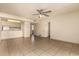 Living room with tile floors, ceiling fan, and open layout with a view to the kitchen at 3313 N 68Th St # 111, Scottsdale, AZ 85251