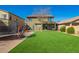 Large backyard featuring manicured synthetic grass, a trampoline, and a play set for children at 33731 N Slate Creek Dr, San Tan Valley, AZ 85143