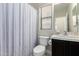 Functional bathroom featuring a toilet, vanity with sink, and a shower with striped curtain at 33731 N Slate Creek Dr, San Tan Valley, AZ 85143