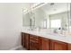 Bright bathroom features a dual sink vanity with tile countertops and ample cabinet space at 33731 N Slate Creek Dr, San Tan Valley, AZ 85143