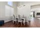 Dining area with hardwood floors, modern chandelier, and natural lighting at 33731 N Slate Creek Dr, San Tan Valley, AZ 85143