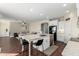 Open-concept kitchen with island seating flows into a comfortable living area, perfect for entertaining at 33731 N Slate Creek Dr, San Tan Valley, AZ 85143