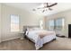 Serene main bedroom with a ceiling fan, large windows, and a comfortable queen-size bed at 33731 N Slate Creek Dr, San Tan Valley, AZ 85143