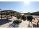 View of a park featuring shade structure, picnic table, grill and bench at 34598 N Elmwood Way, San Tan Valley, AZ 85144