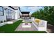 An elegant backyard design with a covered outdoor kitchen, fire pit area, and in-ground pool at 3628 E Clarendon Ave, Phoenix, AZ 85018