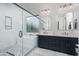 Luxurious bathroom featuring a soaking tub, dual vanity with marble countertops and modern fixtures at 3628 E Clarendon Ave, Phoenix, AZ 85018