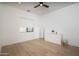 Bright bedroom features wood floors, a ceiling fan, a window and white dresser at 3628 E Clarendon Ave, Phoenix, AZ 85018