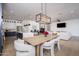 Open-concept dining area with stylish furniture and a view of the kitchen and living spaces at 3628 E Clarendon Ave, Phoenix, AZ 85018