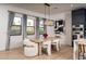 Bright dining area featuring modern light fixtures, ample natural light, and a view of the lush backyard at 3628 E Clarendon Ave, Phoenix, AZ 85018