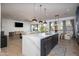 Bright kitchen with a quartz island, stainless steel appliances, and an open layout to the living area at 3628 E Clarendon Ave, Phoenix, AZ 85018