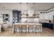 Stunning kitchen with a large waterfall island, stylish pendant lights, and modern two-tone cabinetry at 3628 E Clarendon Ave, Phoenix, AZ 85018