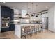 Beautiful kitchen featuring a spacious island with seating, pendant lighting, and stainless steel appliances at 3628 E Clarendon Ave, Phoenix, AZ 85018