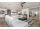 Open concept living room showcasing a white sectional sofa, stylish decor, and seamless flow to the kitchen at 3628 E Clarendon Ave, Phoenix, AZ 85018