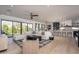 Expansive living room showcasing an open layout with a large sectional sofa and a view of the kitchen at 3628 E Clarendon Ave, Phoenix, AZ 85018