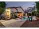 Backyard with a pool, mature landscaping, a covered patio, and beautiful pavers at 3887 E Andre Ave, Gilbert, AZ 85298