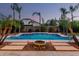 Stunning backyard pool featuring stepping stone pavers, mature landscaping, and a fire pit centerpiece at 3887 E Andre Ave, Gilbert, AZ 85298