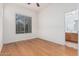 Bright bedroom with wood floors, white walls, and window with shutter blinds at 3887 E Andre Ave, Gilbert, AZ 85298