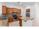 Modern kitchen with stainless steel appliances, granite counters, and wooden cabinets at 3887 E Andre Ave, Gilbert, AZ 85298