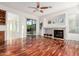 Inviting living room with a ceiling fan, fireplace, and wood flooring at 3887 E Andre Ave, Gilbert, AZ 85298