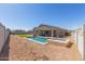 Aerial view of backyard with pool, turf, patio and desert landscaping at 3973 N 310Th Ln, Buckeye, AZ 85396