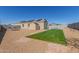 Desert backyard featuring artificial turf, shed, and pool with rock landscaping and solar panels at 3973 N 310Th Ln, Buckeye, AZ 85396