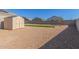 Gravel backyard featuring a shed and artificial turf at 3973 N 310Th Ln, Buckeye, AZ 85396