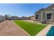 Landscaped backyard featuring a lush artificial grass and a privacy fence at 3973 N 310Th Ln, Buckeye, AZ 85396