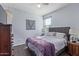 Comfortable bedroom with a bed with gray headboard, soft carpet, and ceiling fan at 3973 N 310Th Ln, Buckeye, AZ 85396