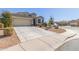 View of a single-Gathering home with a two-car garage and desert landscaping at 3973 N 310Th Ln, Buckeye, AZ 85396