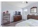 Well-lit bedroom featuring wood floors, a dresser, and a large window for natural light at 3973 N 310Th Ln, Buckeye, AZ 85396