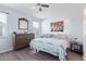 A cozy bedroom with a ceiling fan, and stylish decor at 3973 N 310Th Ln, Buckeye, AZ 85396