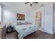 A comfortable bedroom with a ceiling fan and a glimpse of the en-suite bathroom at 3973 N 310Th Ln, Buckeye, AZ 85396