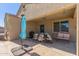 Relaxing outdoor patio with dining table and chairs, umbrella, and grill at 3973 N 310Th Ln, Buckeye, AZ 85396