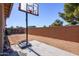 Spacious backyard with basketball hoop and cemented patio pad, great for recreation and outdoor activities at 41124 W Rio Bravo Dr, Maricopa, AZ 85138