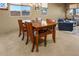 Cozy dining room with a wooden table and four chairs at 41124 W Rio Bravo Dr, Maricopa, AZ 85138