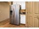 Close-up of a stainless steel refrigerator and a white cabinet space in the kitchen area at 41124 W Rio Bravo Dr, Maricopa, AZ 85138