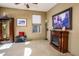 Warm and inviting living room featuring a decorative fireplace, neutral carpet, and ample natural light at 41124 W Rio Bravo Dr, Maricopa, AZ 85138