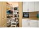 Well-organized pantry with ample shelving and countertop space, adjacent to modern white kitchen cabinets at 41124 W Rio Bravo Dr, Maricopa, AZ 85138