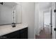 Modern bathroom features a white vanity with dark accents and a mirror at 4133 W Eli Dr, San Tan Valley, AZ 85144