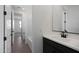 A bathroom featuring a modern vanity with white countertop and black hardware with tiled floor and tub at 4133 W Eli Dr, San Tan Valley, AZ 85144