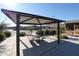 Outdoor picnic area featuring a shade structure, table, benches and nearby landscaping at 4145 W Eli Dr, San Tan Valley, AZ 85144