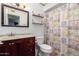 Bathroom featuring a wood vanity, decorative shower curtain, and classic fixtures at 4154 W Grovers Ave, Glendale, AZ 85308