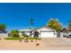 Charming single-story home with desert landscaping, mature trees, and an attached two-car garage at 4154 W Grovers Ave, Glendale, AZ 85308