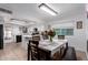 Bright kitchen and dining area with tile floors, white cabinets, and view to the backyard at 4154 W Grovers Ave, Glendale, AZ 85308