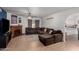 Comfortable living room featuring a brick fireplace, a ceiling fan, and tile floors at 4154 W Grovers Ave, Glendale, AZ 85308