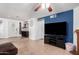 Open-concept living room featuring tile floors, brick fireplace, and natural light at 4154 W Grovers Ave, Glendale, AZ 85308