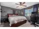 Cozy main bedroom with a ceiling fan, comfortable bed, and natural light at 4154 W Grovers Ave, Glendale, AZ 85308