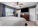 Well-lit main bedroom with a large window, walk in closet, and a ceiling fan at 4154 W Grovers Ave, Glendale, AZ 85308